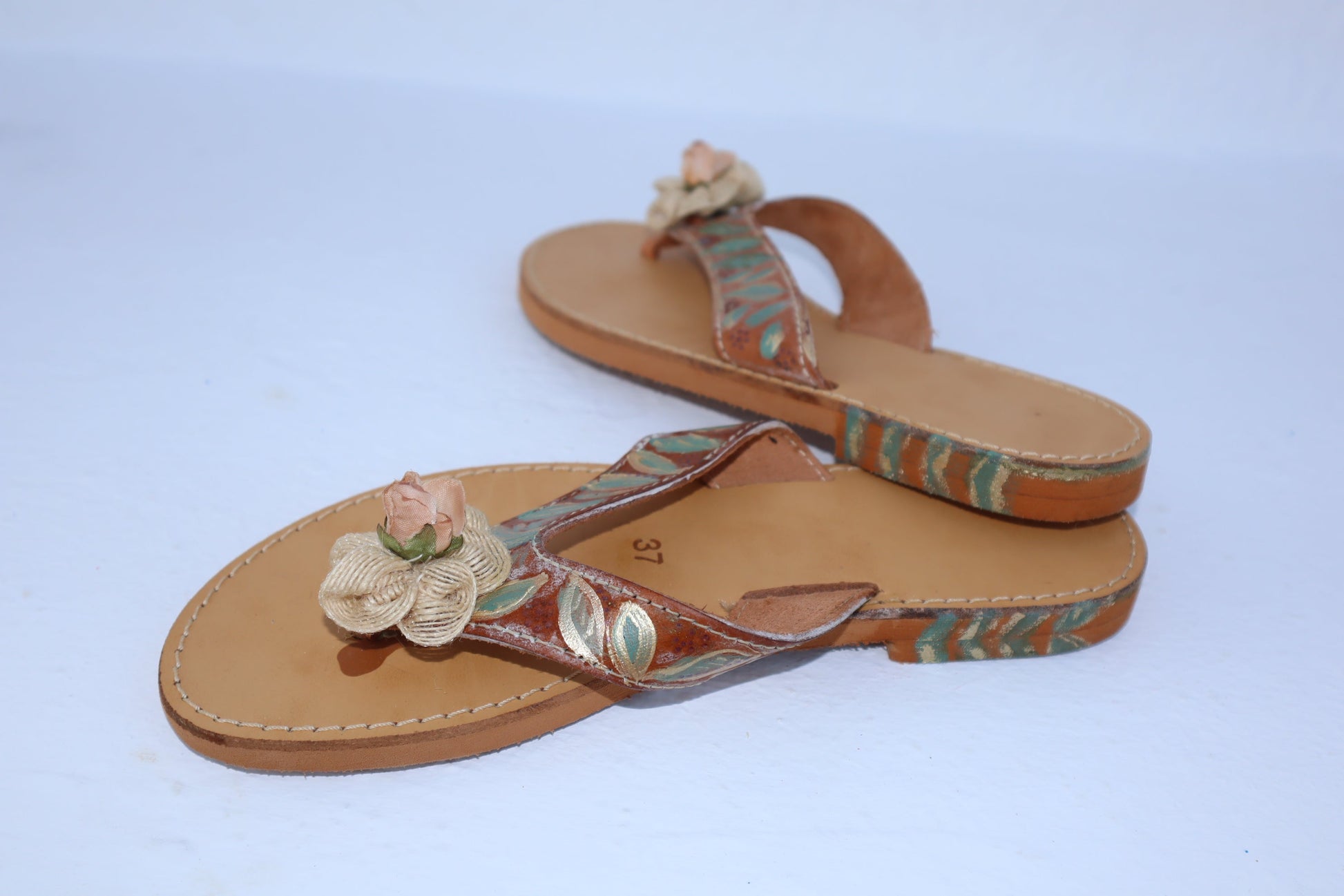 CLOSE UP DETAIL OF HAND-PAINTED ROSE ON TILOS SANDALS